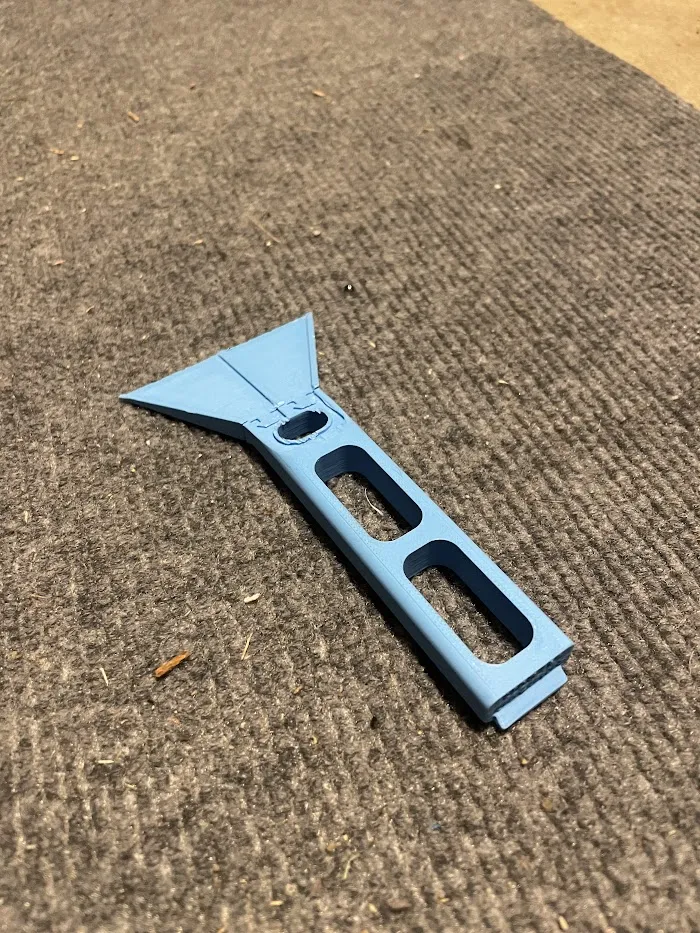 Blue 3D-printed print-bed scraper with a modular blade
