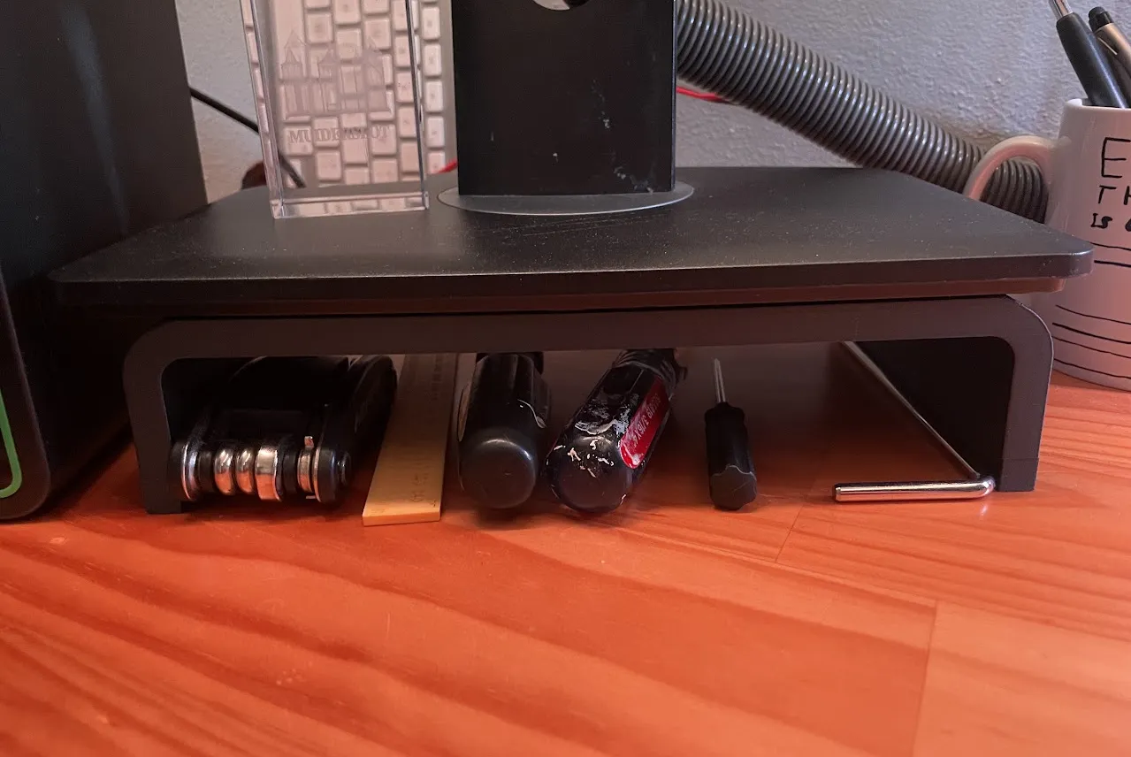 3D-printed monitor stand with tools stored underneath