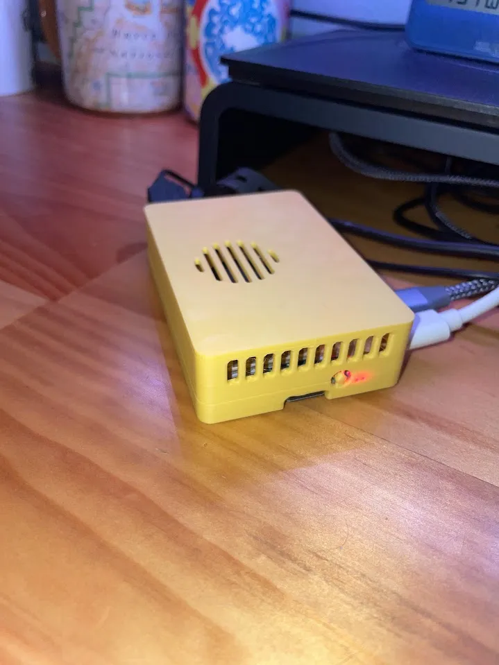 Yellow 3D-printed Raspberry Pi 5 case with ventilation slots